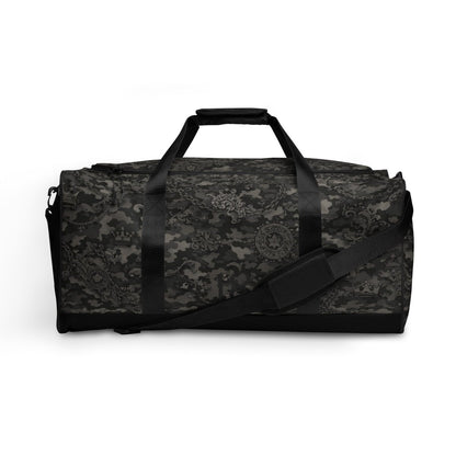 Black duffel bag with camo pattern and chain, crown, and star motifs, adjustable strap